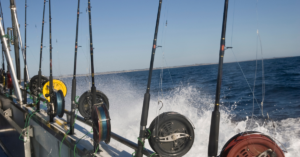 A boat charter with fishing poles off the side
