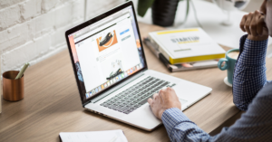 A man on a computer while working on a website's content.