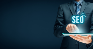 photo of someone holding an SEO shining on a laptop