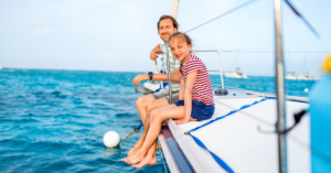 photo of two people on a sailboat