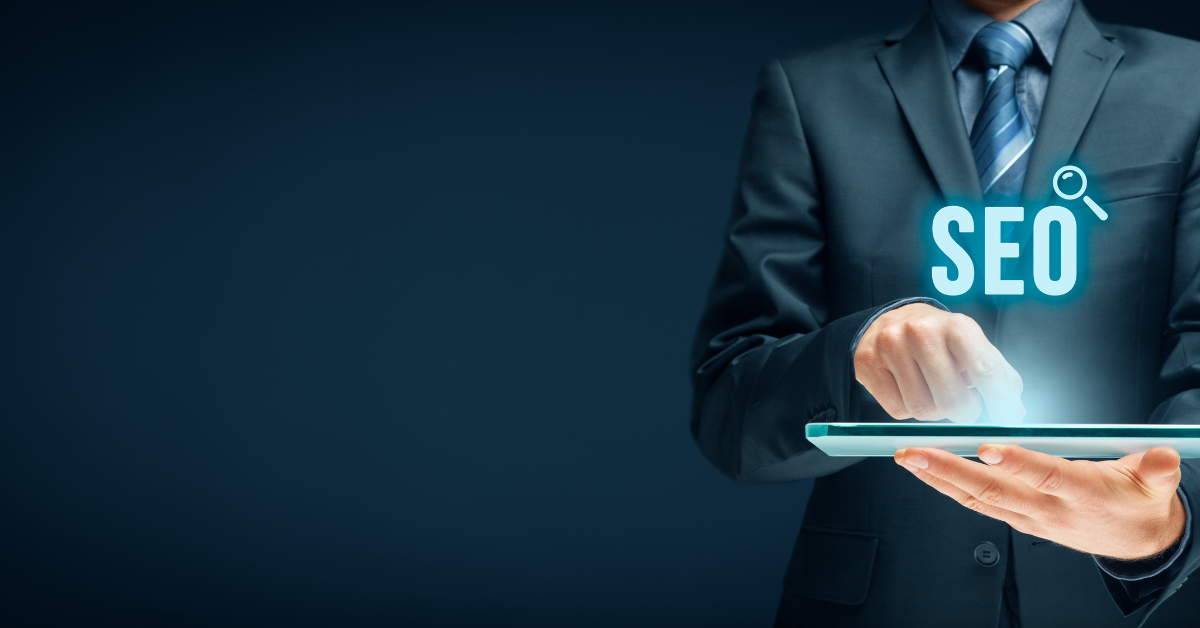 photo of someone holding an SEO shining on a laptop