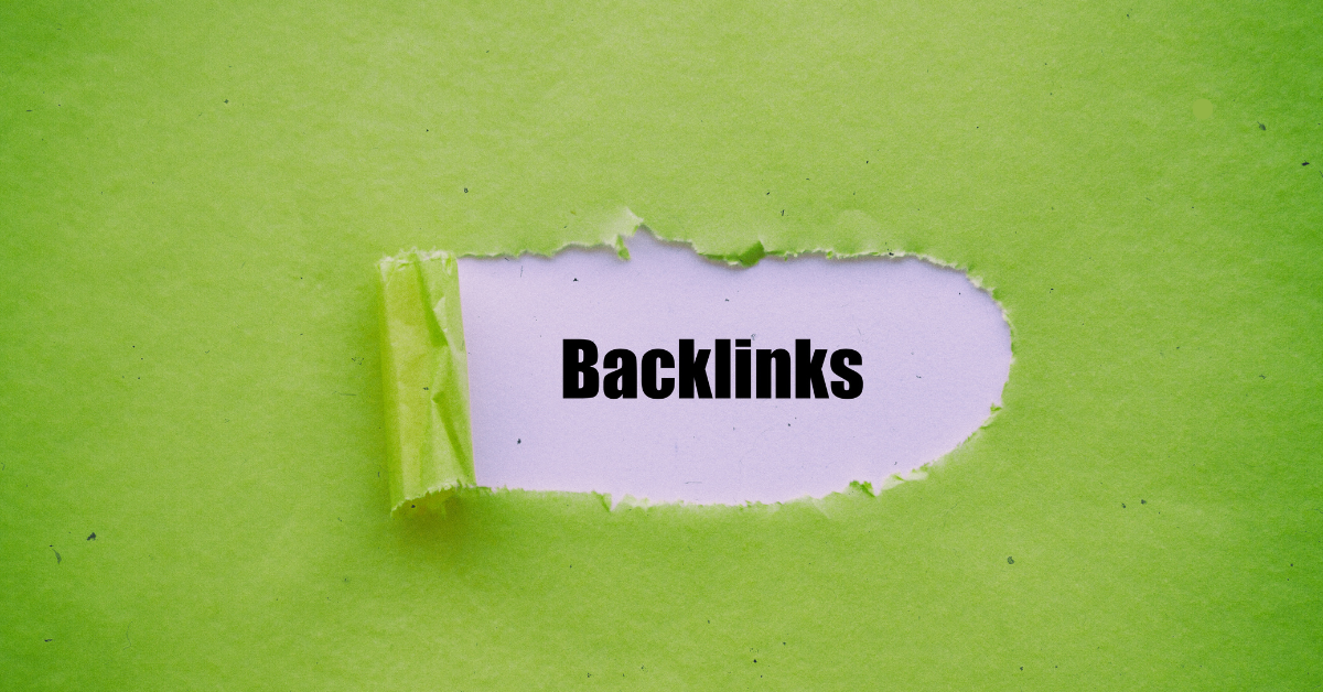 The word "Backlinks" written in black on a white background, revealed through a torn hole in a green piece of paper.