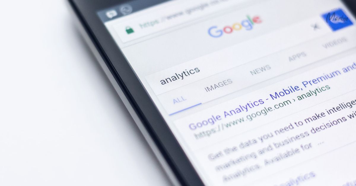 A close-up of a smartphone screen showing a Google search for the word "analytics", with the official Google Analytics website appearing as the top search result.